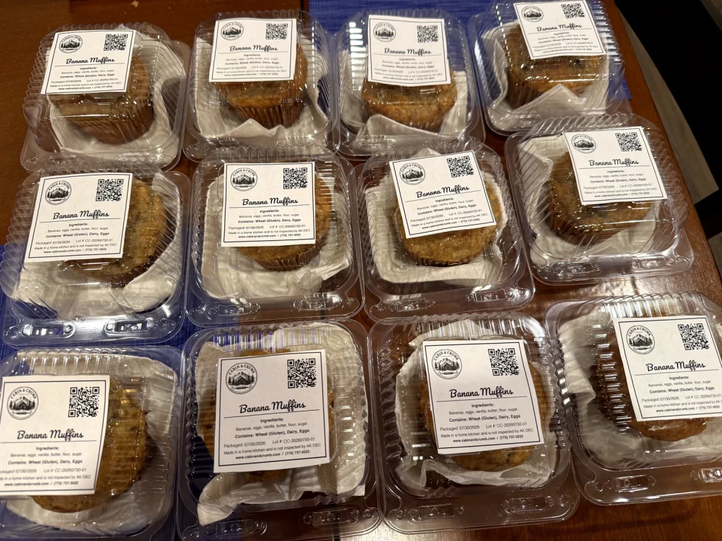 Cabin & Crumb banana muffins in labeled clamshell packaging, ready for pickup