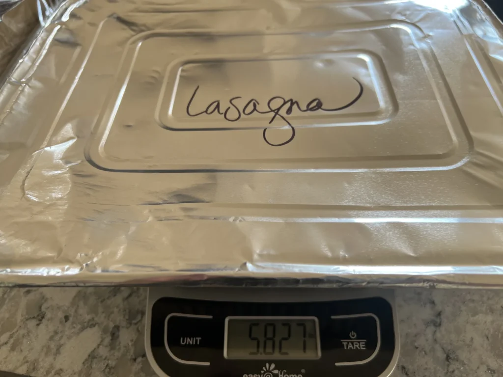 Kitchen scale showing lasagna weight — 5.87 lbs